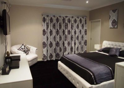 bedroom with purple damask curtains