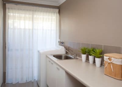 laundry room with white sheer curtains
