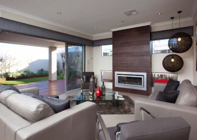 living room with open outdoor deck and padded pelmets
