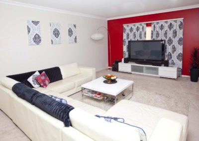 living room with purple damask curtains