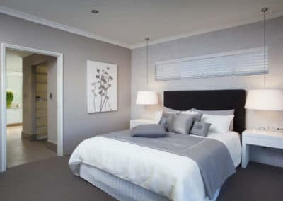 narrow venetian blinds above bed