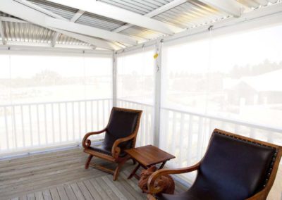 white outdoor blinds on deck