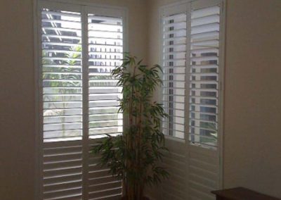 white shutter over tall windows